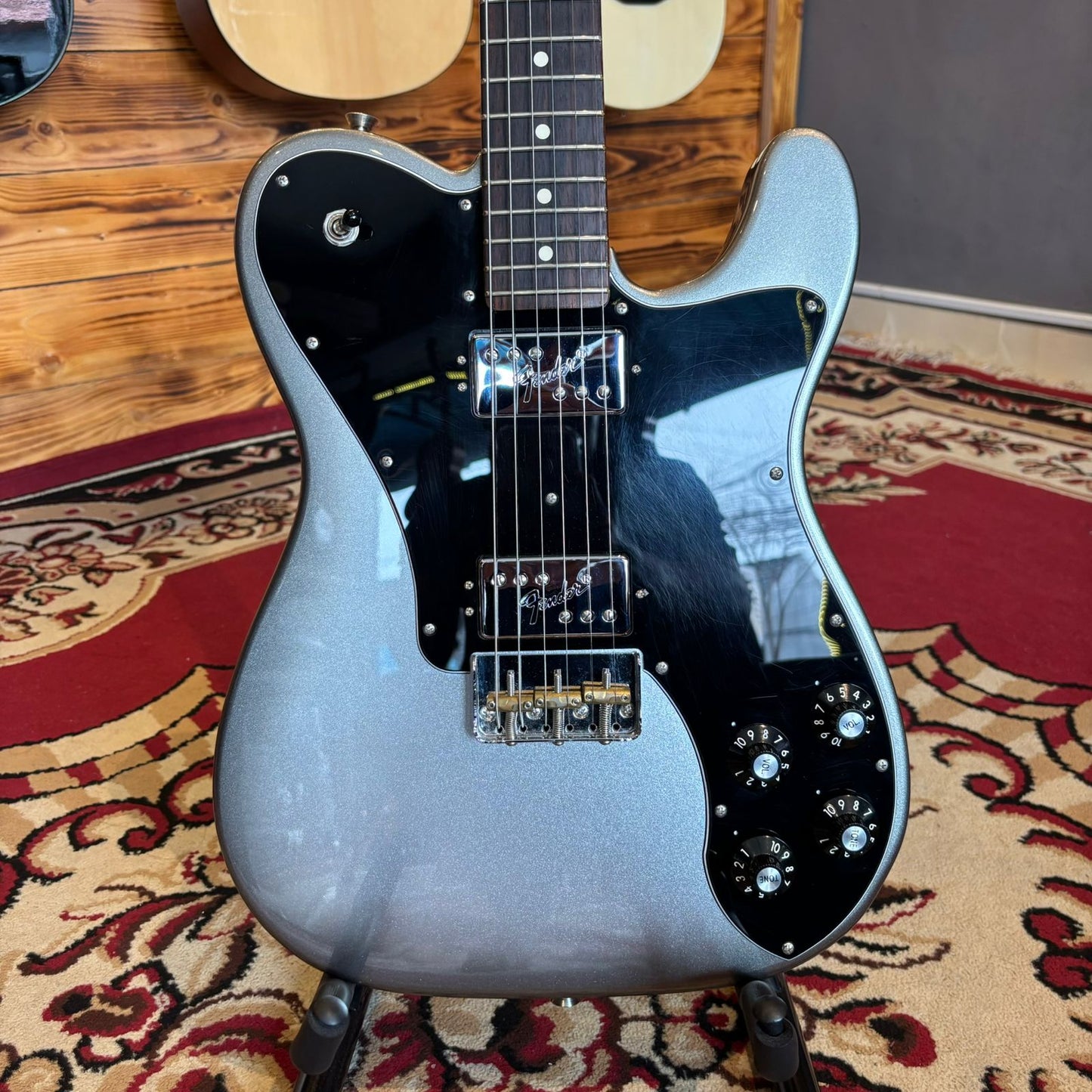 The front body of a Fender American Pro II Telecaster Deluxe electric guitar on a stand.