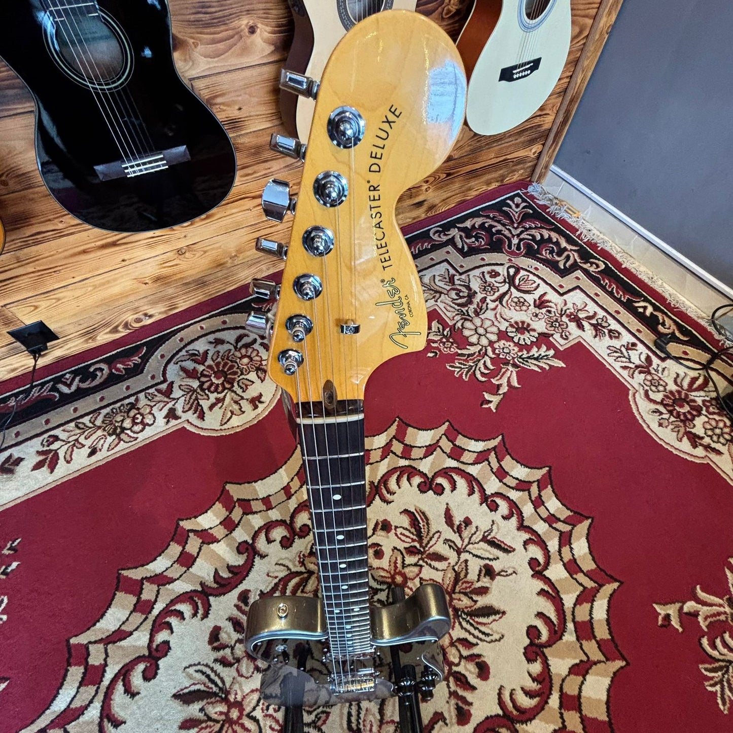 A Fender American Pro II Telecaster Deluxe electric guitar on a stand viewed from above showing the full body