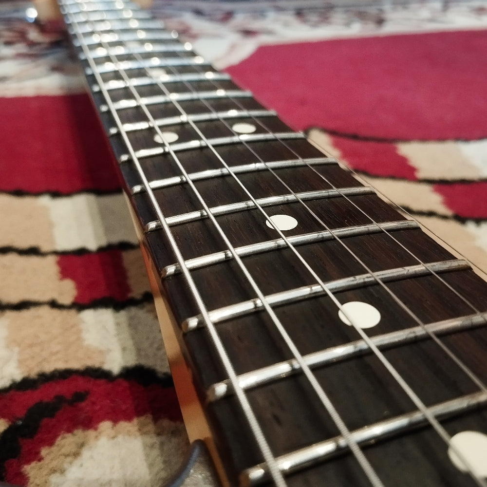 Close-up of the fretboard of a Fender American Pro II Telecaster Deluxe electric guitar, showing the frets, dot inlays, and smooth