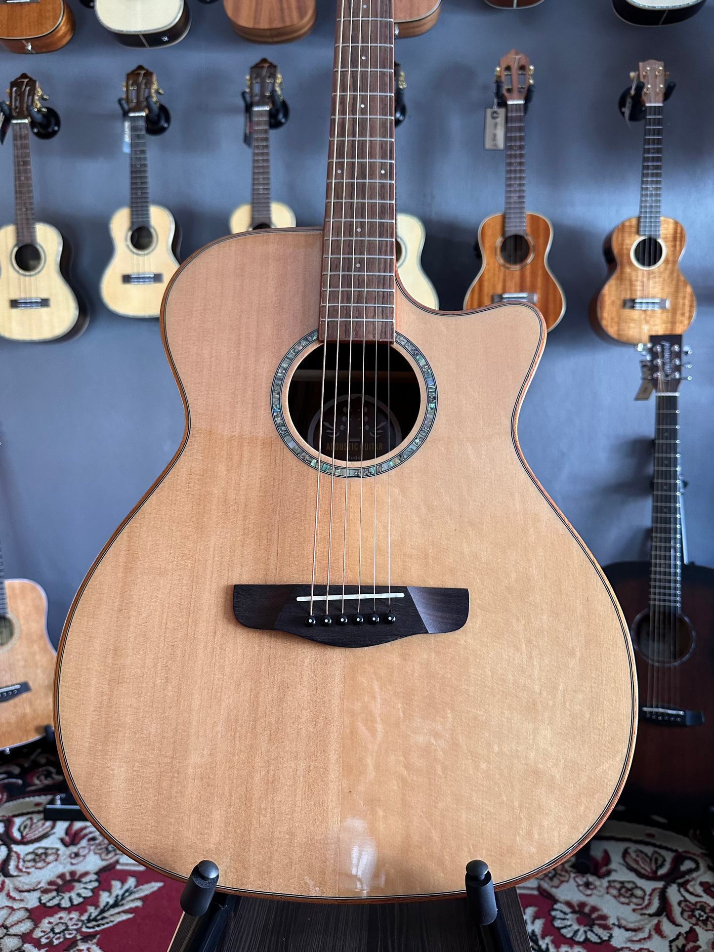 Front body of an acoustic guitar placed on a guitar stand
