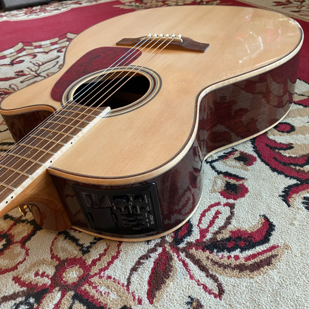 Acoustic guitar on a patterned rug