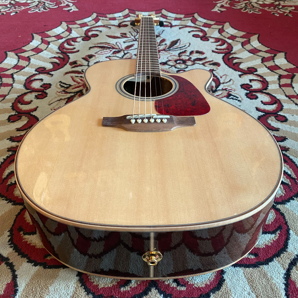 Acoustic guitar on a patterned rug