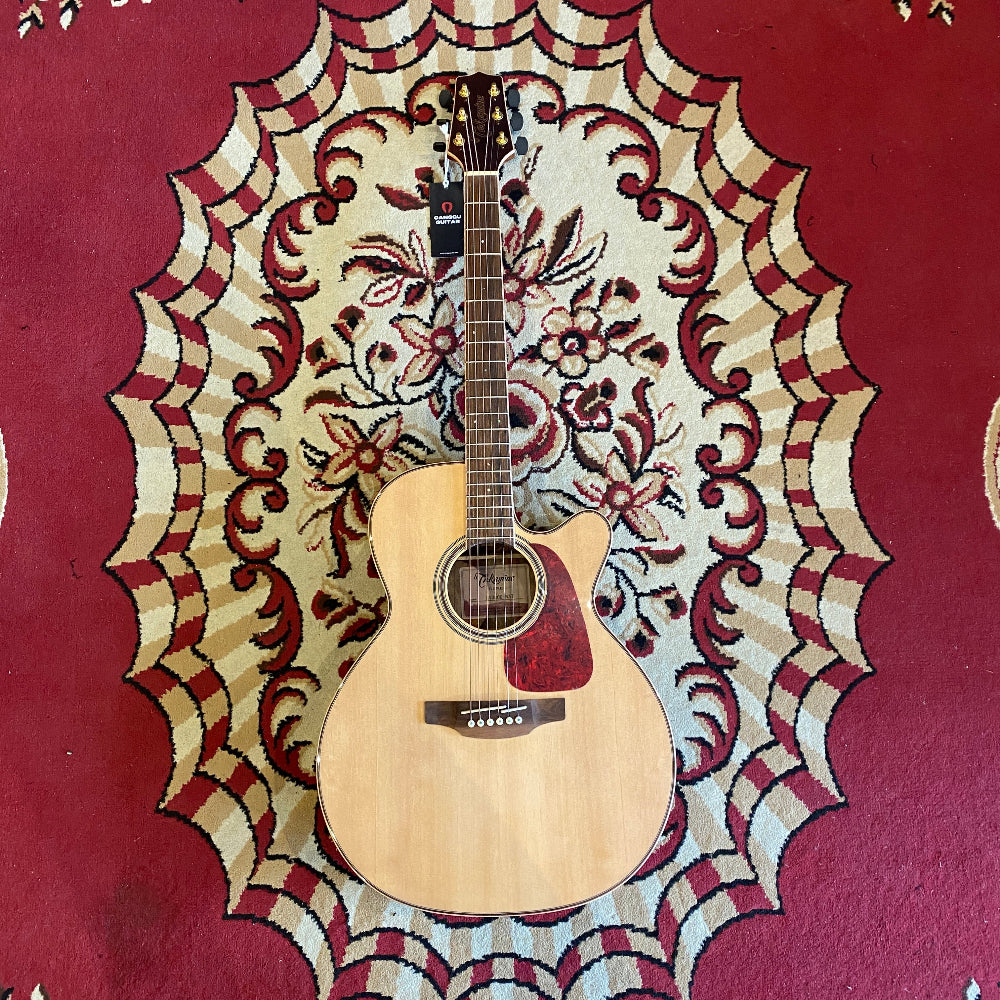 A Takamine GN93CE Natural acoustic guitar resting on a red carpet, featuring a glossy natural finish and NEX-style body.