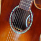 Model tag of an acoustic guitar, visible through the sound hole, displaying the brand name and model number.
