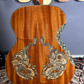 The back side of the Blueberry Dragon guitar with a smooth wooden finish and a subtle continuation of the dragon-themed design.