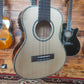Front body of a TOM ukulele, showing the sound hole, bridge, and smooth wood finish.