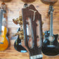 Front headstock of a TOM ukulele, featuring the TOM logo and tuning pegs.