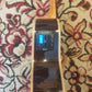 Side body of a TOM ukulele showing the UK500T chromatic tuner preamp system with control buttons and display screen.