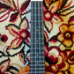  Fretboard of a ukulele showing the frets, dot inlays, and smooth wooden surface