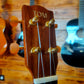 Headstock of a ukulele with tuning pegs and a visible brand logo