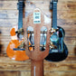 Back headstock of a TOM ukulele, showing tuning pegs and a barcode sticker.