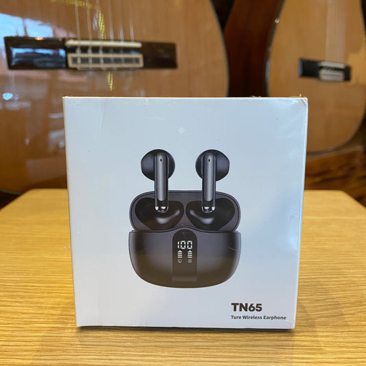 Box of TN65 earbuds on a wooden surface with a guitar in the background