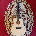 Acoustic guitar with a natural wood finish, placed on a patterned red and white background.