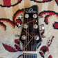 Front view of an acoustic guitar showing the dryer-style tuning pegs on the headstock.