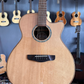 Front body of an acoustic guitar placed on a guitar stand