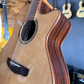 Side body of an acoustic guitar placed on a guitar stand