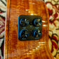 Close-up of the ukulele’s preamp system on the side