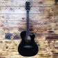 A Cetta OM28CE acoustic guitar resting on a wood wall, featuring a natural wood finish and cutaway design.